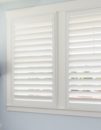 White plantation shutters with hidden tilt rods in Houston